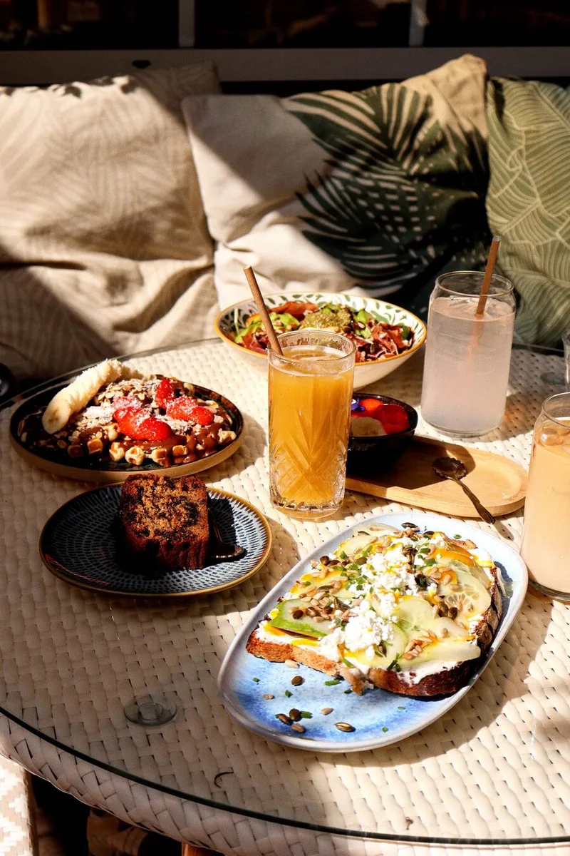 Table de brunch d'UTOPY en terrasse, coussins à motif palme